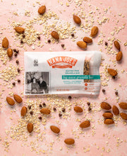 Load image into Gallery viewer, Big Wave Bar by Nana Joes Granola, front on pink background with almonds and quinoa
