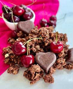 Nana Joe's granola with cherries and BTR Nation chocolate hearts on a pink cloth