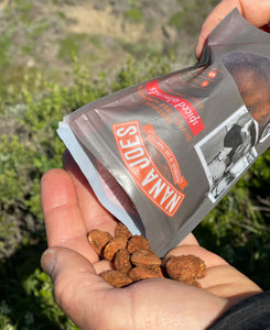A bag of Cumin Spiced Almonds by Nana Joes Granola being poured into a hand